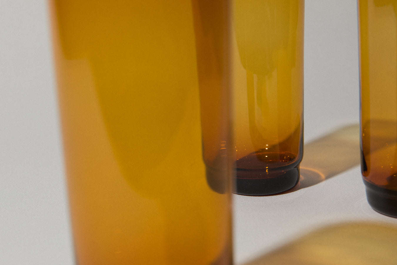 Set of three amber drinking GLASSES tall