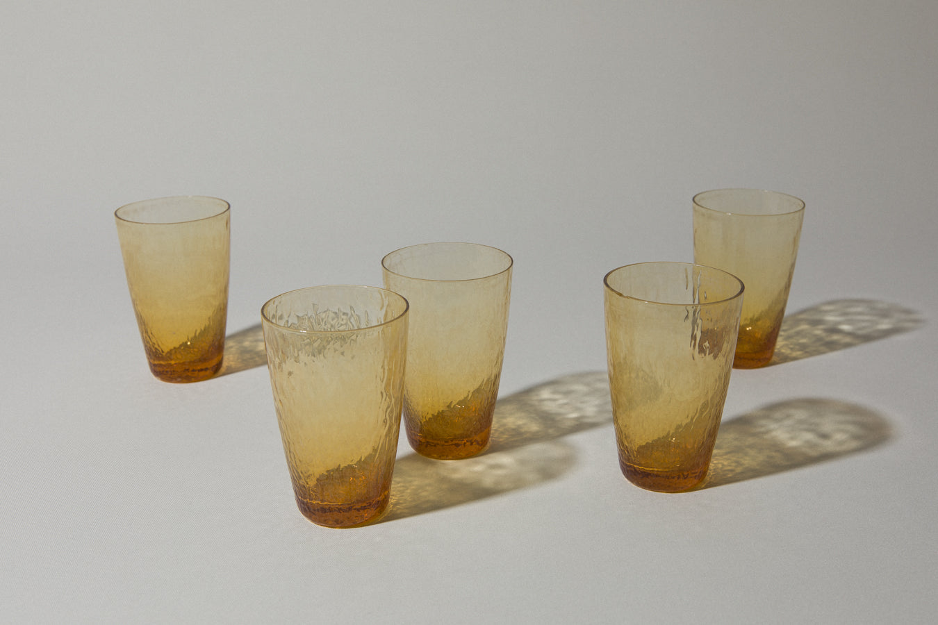 Set of five amber textured glass TUMBLERS