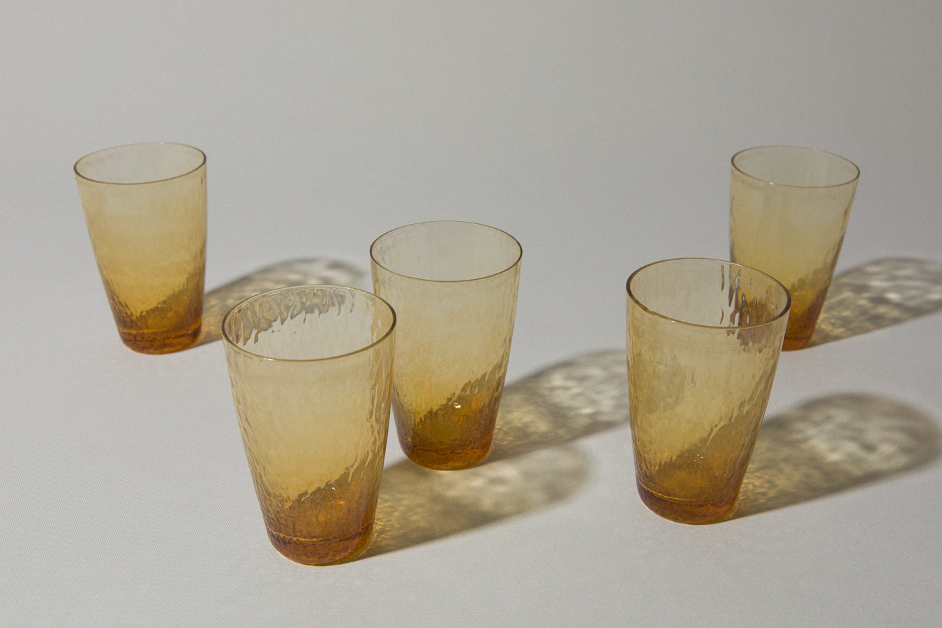 Set of five amber textured glass TUMBLERS