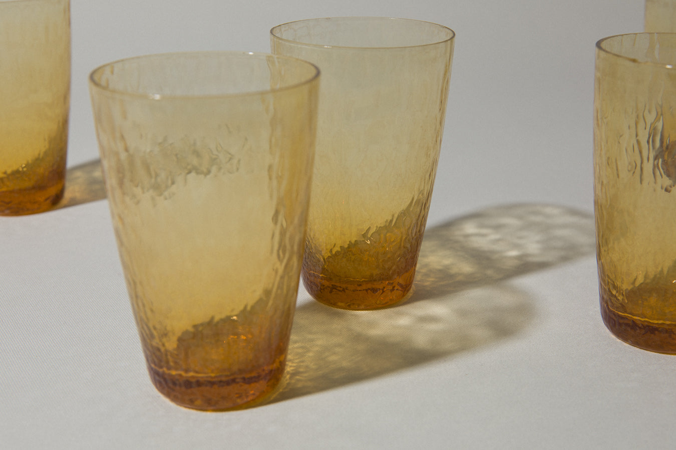 Set of five amber textured glass TUMBLERS