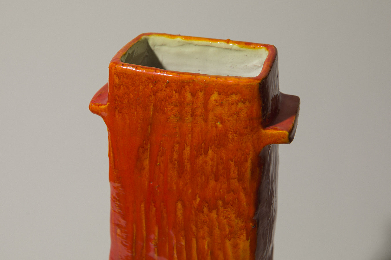 Orange rectangular VASE with handles by Béla Mihály