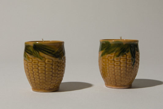 Set of two beeswax CANDLE in corn-motif faience holder