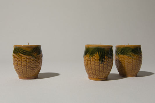 Set of three beeswax CANDLE in corn-motif faience holder