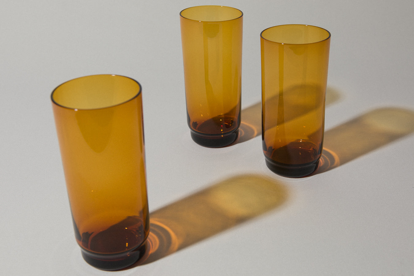 Set of three amber drinking GLASSES tall